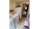 Functional laundry area equipped with appliances, tile floor, and access to the adjacent room at 425 Roselawn Pl, Charlotte, NC 28211