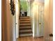 View of a wooden staircase leading up to the next floor with an adjacent door and light-colored walls at 425 Roselawn Pl, Charlotte, NC 28211
