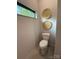 Bright bathroom with modern toilet, window with leafy view, and decorative wooden plates on the wall at 444 Starnes Circle Dr, Taylorsville, NC 28681