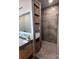 Bathroom features a modern shower with gray tiling, built-in shelves, double sink and concrete counters at 444 Starnes Circle Dr, Taylorsville, NC 28681