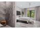 Modern bedroom with gray walls, a large window and a king size bed featuring white bedding and a dark headboard at 444 Starnes Circle Dr, Taylorsville, NC 28681