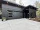 Modern home with a dark exterior, featuring a flat roof, and concrete driveway at 444 Starnes Circle Dr, Taylorsville, NC 28681