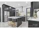 Contemporary kitchen boasts a large island with seating, stainless steel appliances, and sleek, dark cabinetry at 444 Starnes Circle Dr, Taylorsville, NC 28681