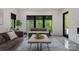 Well-lit living room with large windows, comfortable seating, and stylish interior design at 444 Starnes Circle Dr, Taylorsville, NC 28681