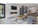 Modern living area featuring a linear fireplace, and an open floorplan flowing into the kitchen at 444 Starnes Circle Dr, Taylorsville, NC 28681