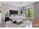 Bright main bedroom with large windows, neutral colors, and concrete floors at 444 Starnes Circle Dr, Taylorsville, NC 28681