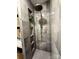 This shower features gray tiling, a rainfall shower head, a handheld shower head and built in shelves at 444 Starnes Circle Dr, Taylorsville, NC 28681