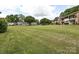 Manicured lawn area with mature trees at 4609 Coronado Dr, Charlotte, NC 28212