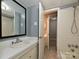 Bathroom features white vanity, tiled shower, and neutral color scheme at 4609 Coronado Dr, Charlotte, NC 28212