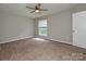 Bright bedroom features neutral walls and carpet, plus a window for natural light at 4609 Coronado Dr, Charlotte, NC 28212