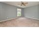 Bedroom with neutral walls and carpet, featuring a window with natural light at 4609 Coronado Dr, Charlotte, NC 28212
