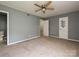 Spacious bedroom featuring neutral carpet and a ceiling fan for comfort at 4609 Coronado Dr, Charlotte, NC 28212