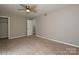 Neutral-toned bedroom featuring carpet, ceiling fan, and closet access at 4609 Coronado Dr, Charlotte, NC 28212