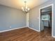 Cozy dining room with wood floors, neutral walls and chandelier lighting at 4609 Coronado Dr, Charlotte, NC 28212