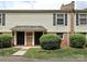 Charming townhouse exterior with well-maintained landscaping, brick accents, and neutral siding at 4609 Coronado Dr, Charlotte, NC 28212