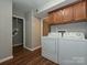 Convenient laundry area with washer, dryer, and upper cabinets for storage at 4609 Coronado Dr, Charlotte, NC 28212