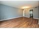 Spacious living room with laminate flooring and views to the dining room at 4609 Coronado Dr, Charlotte, NC 28212