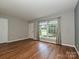Living room featuring wood floors and ample natural light at 4609 Coronado Dr, Charlotte, NC 28212