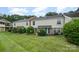 Backyard features well-manicured lawn and mature shrubbery, offering a serene outdoor space at 4609 Coronado Dr # N, Charlotte, NC 28212