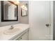 Bathroom featuring a vanity with a mirror and a sink with a white door at 4609 Coronado Dr # N, Charlotte, NC 28212