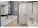 Cozy bathroom with a tub, shower, vanity, and toilet at 4609 Coronado Dr # N, Charlotte, NC 28212