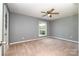 Spacious bedroom features a ceiling fan, neutral walls, and a window for natural light at 4609 Coronado Dr # N, Charlotte, NC 28212