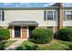 Inviting exterior of a townhome featuring a brick facade, dark doors, and manicured landscaping at 4609 Coronado Dr # N, Charlotte, NC 28212