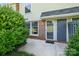 Front door and small patio framed by lush landscaping at 4609 Coronado Dr # N, Charlotte, NC 28212