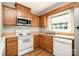 Well-lit kitchen boasting stainless steel appliances, wood cabinetry, and a bright window at 4609 Coronado Dr # N, Charlotte, NC 28212