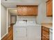 A compact kitchen area with a washer and dryer hookup next to the appliances at 4609 Coronado Dr # N, Charlotte, NC 28212