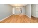 A view of a spacious living room featuring hardwood floors, neutral walls, and ample natural light at 4609 Coronado Dr # N, Charlotte, NC 28212