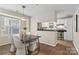 Bright dining area featuring hardwood floors, modern lighting, and an open view to the kitchen at 611 Olmsted Park Pl # C, Charlotte, NC 28203