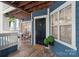 Exterior view of condo entrance with black door, topiaries, and adjacent patio at 611 Olmsted Park Pl # C, Charlotte, NC 28203