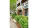 Exterior view of condo entrance with brick pillars, unit number, and landscaped bushes at 611 Olmsted Park Pl # C, Charlotte, NC 28203