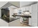 Well-equipped kitchen featuring stainless steel appliances, granite countertops, and white cabinetry at 611 Olmsted Park Pl # C, Charlotte, NC 28203