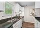 Bright kitchen featuring granite counters, stainless steel appliances, and ample storage space at 611 Olmsted Park Pl # C, Charlotte, NC 28203