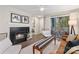 Cozy living room with fireplace, ceiling fan, hardwood floors, and a sliding glass door to the balcony at 611 Olmsted Park Pl # C, Charlotte, NC 28203