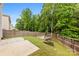 Backyard with a wooden deck and fence, with grass and greenery at 614 Oldham Ln, Rock Hill, SC 29732