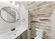 Stylish bathroom featuring unique wood plank accent wall and a round mirror at 614 Oldham Ln, Rock Hill, SC 29732