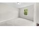 Neutral bedroom featuring a window that brings in natural light and gray carpet at 614 Oldham Ln, Rock Hill, SC 29732
