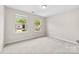 Cozy bedroom featuring plush carpeting, neutral paint, and sunny windows at 614 Oldham Ln, Rock Hill, SC 29732