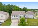 Aerial view of a two-story home, showcasing its neat landscaping, gray siding, and attached two-car garage at 614 Oldham Ln, Rock Hill, SC 29732