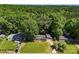 Scenic aerial shot showcases a green home flanked by lush, mature trees, offering a serene, private setting at 619 Archibald Rd, Concord, NC 28025