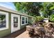 The spacious deck includes a table and chairs with a view of the green surroundings at 619 Archibald Rd, Concord, NC 28025