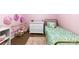 Bright bedroom featuring pink walls, area rug, and decorative accents at 619 Archibald Rd, Concord, NC 28025