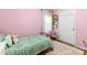 Bright bedroom featuring pink walls, area rug, and decorative accents at 619 Archibald Rd, Concord, NC 28025