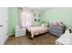 Cozy bedroom featuring mint green walls and a twin bed with pink bedding at 619 Archibald Rd, Concord, NC 28025