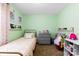 Comfortable bedroom featuring mint green walls and a twin bed with pink bedding at 619 Archibald Rd, Concord, NC 28025