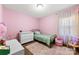 Charming bedroom with pink walls, area rug, and decorative accents at 619 Archibald Rd, Concord, NC 28025