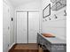Modern entryway with coat hooks, storage cabinet, and stylish accents at 619 Archibald Rd, Concord, NC 28025